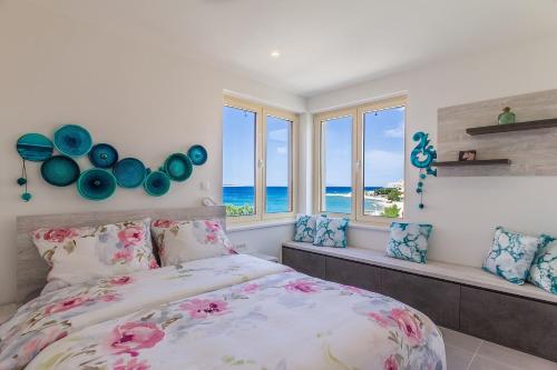 a bedroom with a bed with a view of the ocean at Seaside house for families with children Mandre, Pag - 22603 in Kolan