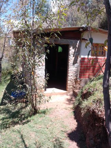 a door to a small house with a yard at Finca el pinar in Huaraz