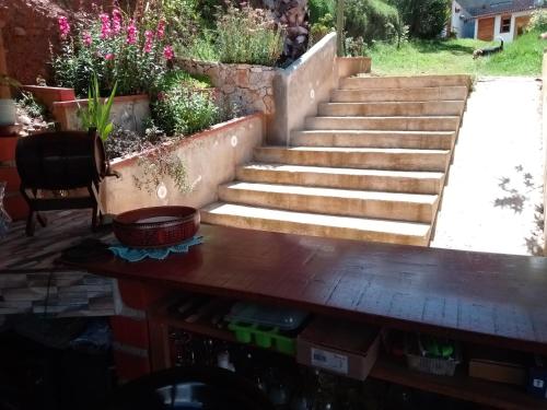 a set of stairs in a garden with a table at Finca el pinar in Huaraz