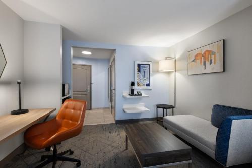 a living room with a couch and a chair at Holiday Inn Express Savannah Airport by IHG in Savannah