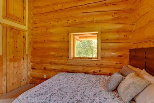 a bedroom with a bed in a log cabin at Legacy Mountain Lodge on 40-Acre Ranch with Views! in Palmer