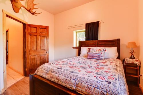 a bedroom with a bed with a wooden headboard at Legacy Mountain Lodge on 40-Acre Ranch with Views! in Palmer