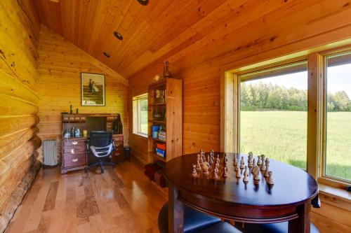 a room with a chess board on a table in a cabin at Legacy Mountain Lodge on 40-Acre Ranch with Views! in Palmer