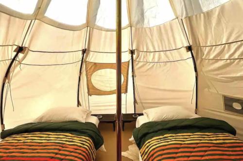 a bedroom with two beds in a tent at Paradise Ranch Inn - Lucky Tent in Three Rivers