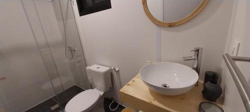 a bathroom with a white toilet and a mirror at Hojas de Otoño SOLO CON SEÑA in Piriápolis