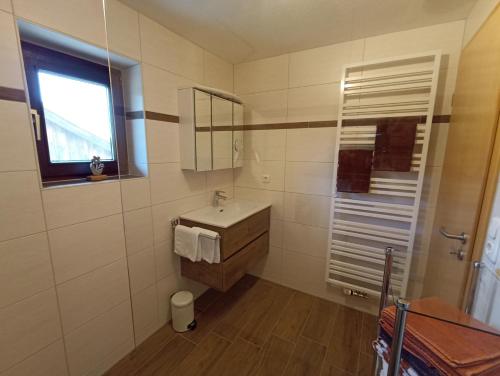 a bathroom with a sink and a mirror at Landhaus Kamml in Anger