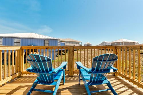 two blue chairs sitting on a deck at Just Chillin' in Dauphin Island