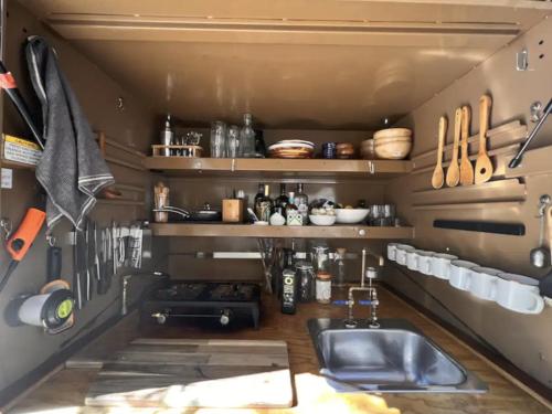 a kitchen with a sink and a counter with utensils at Paradise Ranch Inn - Liberated Tent in Three Rivers