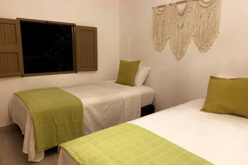 Ένα ή περισσότερα κρεβάτια σε δωμάτιο στο Cabaña acogedora en el Suroeste Antioqueño