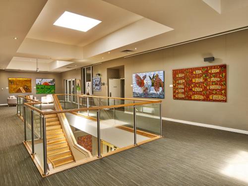 a lobby with stairs and paintings on the wall at Quest Albury on Townsend in Albury