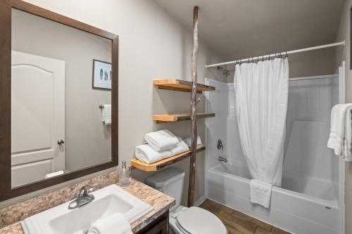 a bathroom with a sink and a toilet and a mirror at Dreamcatcher in West Yellowstone