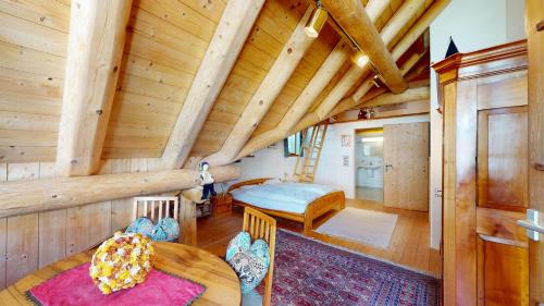 a log cabin with a bedroom and a living room at Abitaziun Chesa Talvo - S-chanf in S-chanf