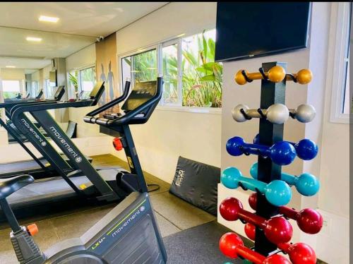 a gym with treadmills and a treadmill at Harmonia Flat's - Aeroporto Gru in Guarulhos