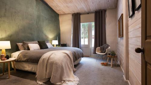 a bedroom with a large bed and a window at Forest Estate Daylesford in Glenlyon