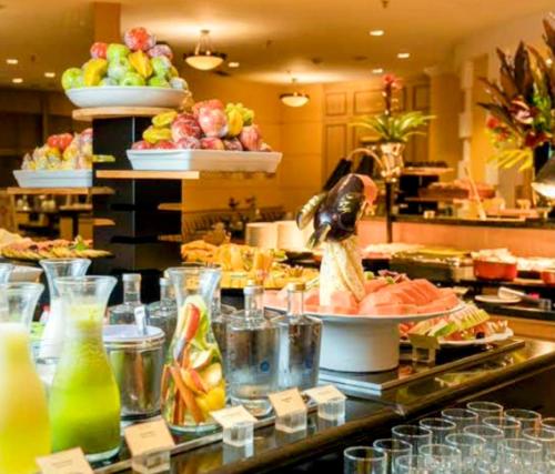 a buffet line with a bunch of food and drinks at Hotel Funchal JK - Itaim BiBi - Urban Duplex Deluxe Studio - First Class - Collors Edition - By HouseNN in Sao Paulo