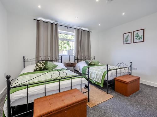 um quarto com 2 camas e uma janela em Uk46915 - 2 Orchard Farm Cottage em East Grinstead