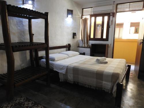 a bedroom with a bed and a bunk bed at Apart Hotel Casa Grande in Natal