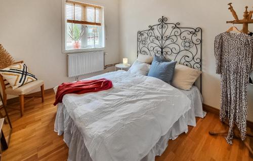 1 dormitorio con 1 cama blanca grande con almohadas azules en 1 Bedroom Awesome Apartment In Stenkullen en Stenkullen