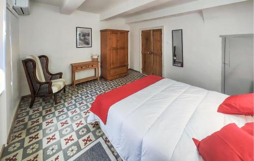 a bedroom with a bed and a desk and chairs at Awesome Home In Faugres With Private Swimming Pool, Can Be Inside Or Outside in Faugères