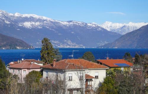 a group of houses with mountains in the background at Stunning Apartment In Germignaga Va in Germignaga