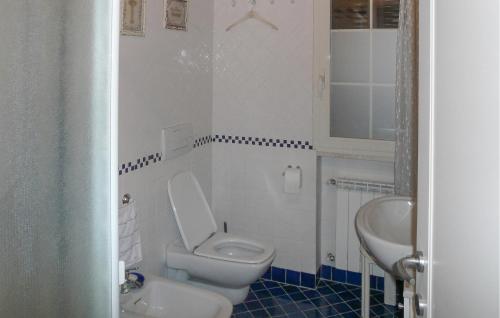 a bathroom with a white toilet and a sink at Awesome Apartment In Germignaga va With Outdoor Swimming Pool in Germignaga