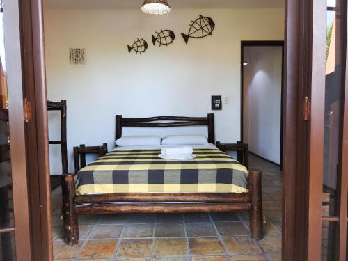 a bedroom with a bed with a striped blanket on it at Apart Hotel Casa Grande in Natal