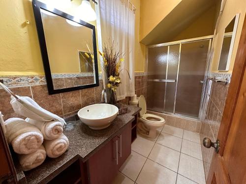 a bathroom with a sink and a toilet and a shower at Little paradise in Tela