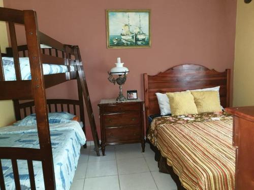 a bedroom with two bunk beds and a dresser at Little paradise in Tela