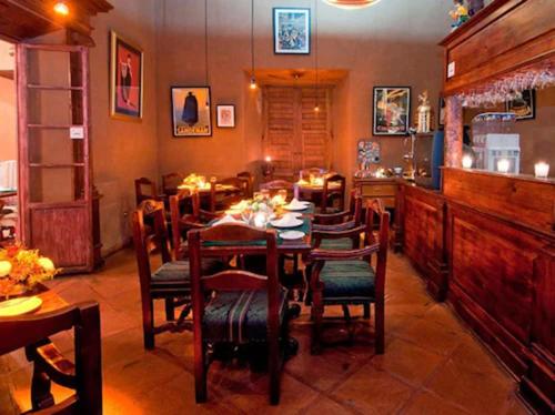 a dining room with a table and chairs at Mansion de los Sueños in Pátzcuaro