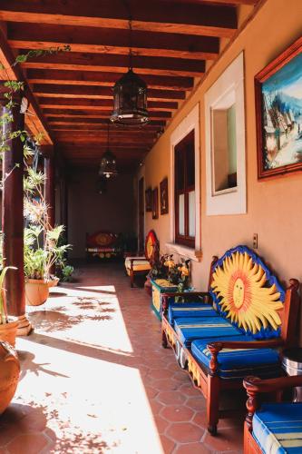 a row of blue benches sitting on a patio at Mansion de los Sueños in Pátzcuaro