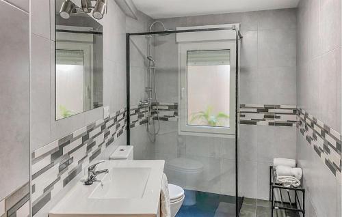 a white bathroom with a sink and a toilet at 3 Bedroom Amazing Apartment In Luanco in Luanco