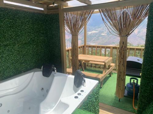 a bath tub in a room with a deck at Chalet El Pinal - Copacabana in Copacabana