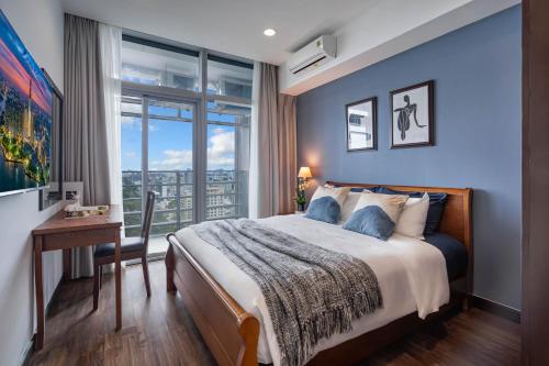 a bedroom with a bed and a desk and a window at Spacious Central Apartments for Group and Family - Sailing Tower in Ho Chi Minh City