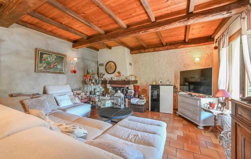 un salon avec des canapés et une table ainsi qu'une cuisine dans l'établissement Lovely Home In Saint-Privat-Des-Vieux, à Saint-Privat-des-Vieux