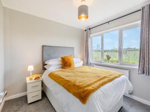 a bedroom with a bed and a large window at Church View - Uk46896 in Kinlet