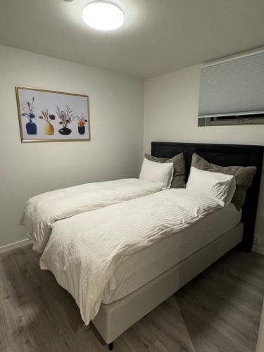 a bedroom with a large bed with white sheets at Home for your trip in Klofta