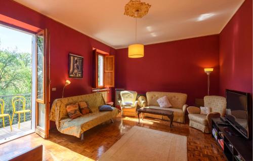 a living room with red walls and a couch and chairs at Amazing Apartment In Montefelcino in Montefelcino