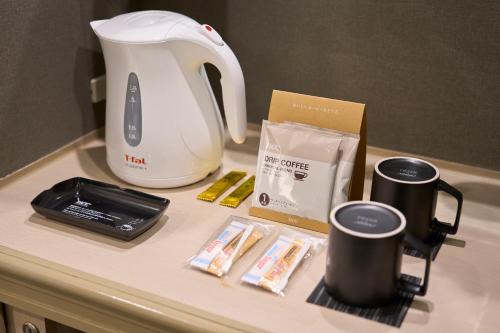 a counter with two coffee cups and a tea kettle at Rihga Royal Hotel Kokura Fukuoka in Kitakyushu