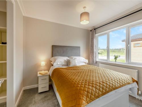 a bedroom with a bed and a window at Park View - Uk46898 in Kinlet