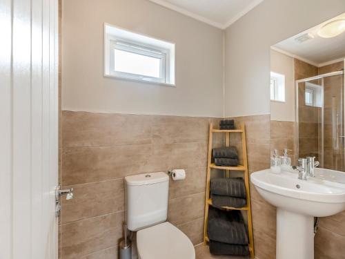 a bathroom with a toilet and a sink at Park View - Uk46898 in Kinlet