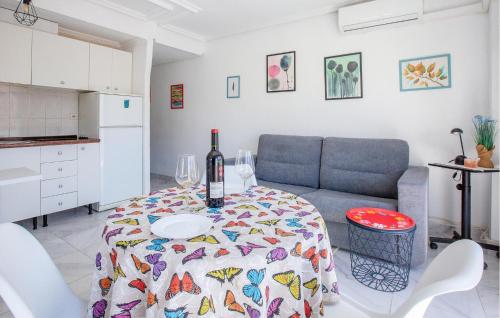 a living room with a table with a wine bottle on it at Stunning Apartment In Torrevieja With Kitchen in Torrevieja