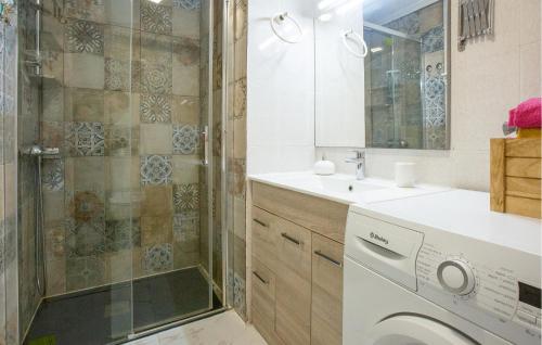 a bathroom with a shower and a washing machine at Stunning Apartment In Torrevieja With Kitchen in Torrevieja