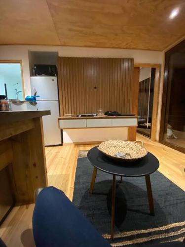 a living room with a table and a kitchen at Casablanca Tiny Home con Hot tub in Lagunillas
