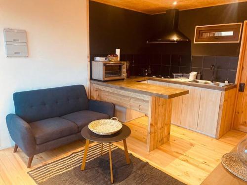a kitchen with a couch and a table in a room at Casablanca Tiny Home con Hot tub in Lagunillas