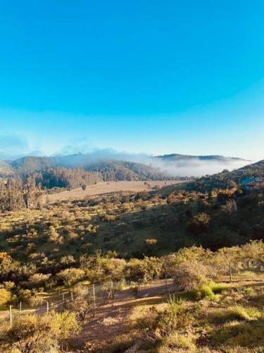a view of a valley with clouds in the hills at Casablanca Tiny Home con Hot tub in Lagunillas