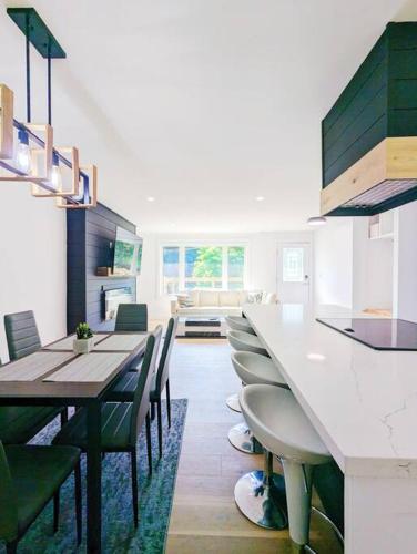 a kitchen with a long table and chairs in a room at The Lilac Bungalow in Kingston