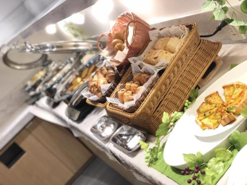 a shelf with a bunch of baskets of food on it at Citadines Shinjuku Tokyo in Tokyo