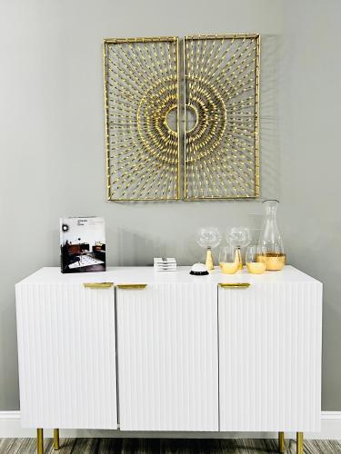 a white cabinet in a room with a mirror at *The Gemstone* Newly Renovated, Stylish, Spacious in Ladson
