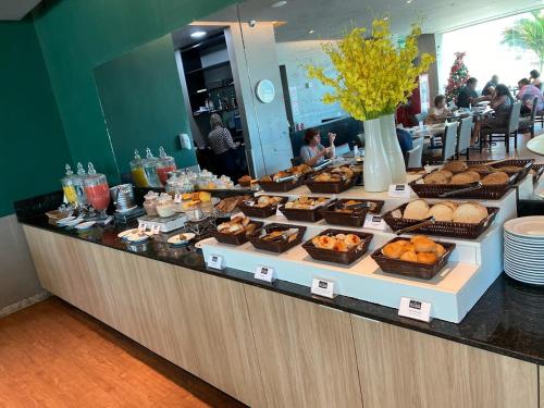 a buffet line with a variety of pastries and desserts at Flat 10 andar Hotel Costa Mar acesso direto praia in Recife