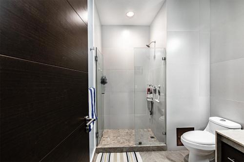 a bathroom with a shower and a toilet at Golf & Beach Haven in Tulum
